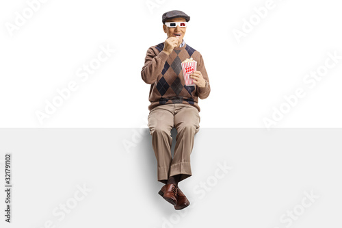 Elderly man on a panel with popcorn and 3d movie glasses