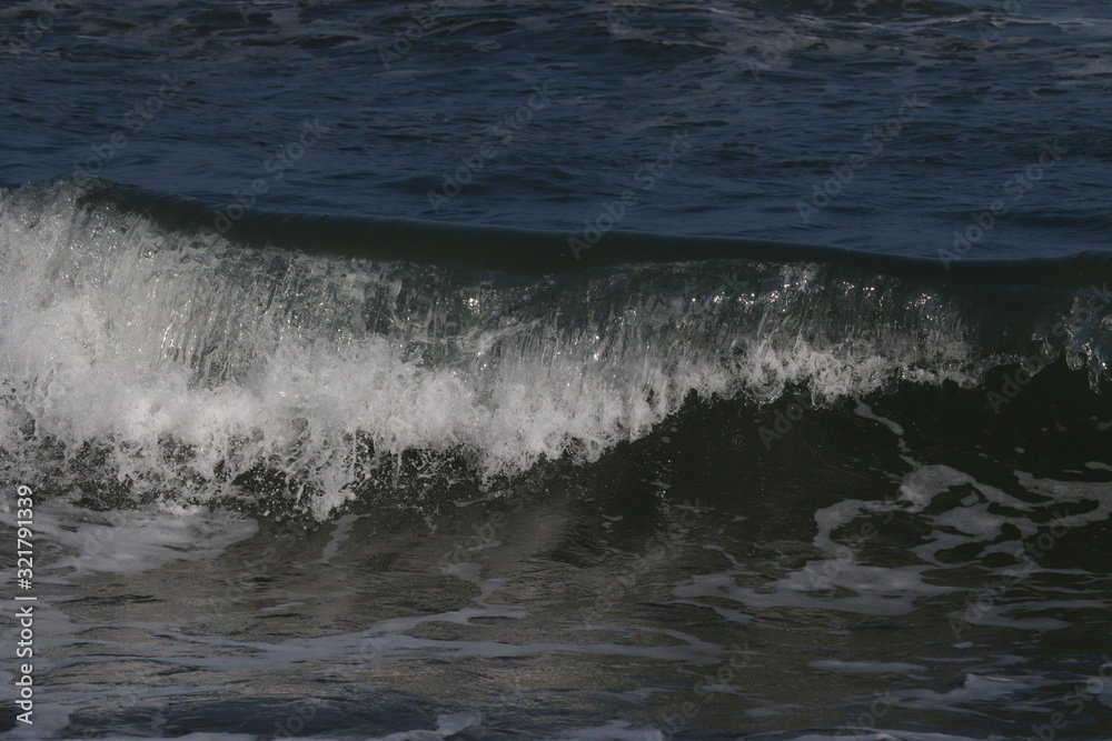 Close up soft wave lapped the sandy beach, Summer Background Close up soft wave lapped the sandy beach, Summer Background