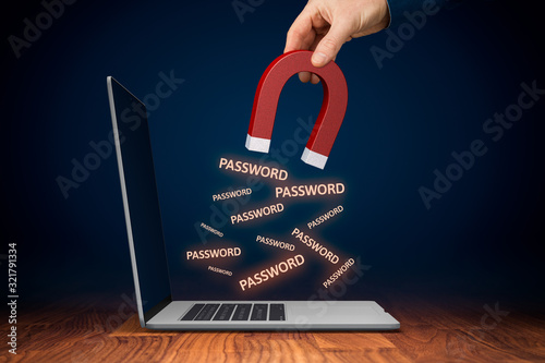 Leaked pwned passwords, data breach, cybersecurity and hacked stolen passwords concepts. Hand with magnet steal passwords from unprotected computer by spyware. photo
