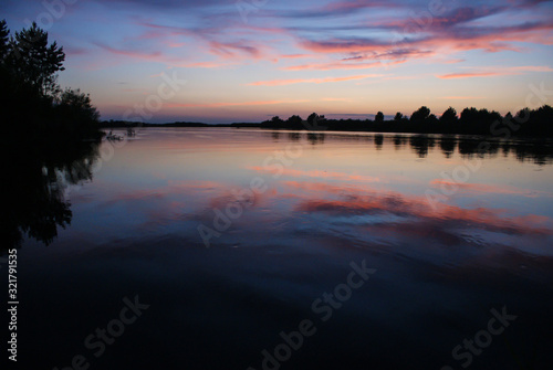 Reflection of the sunset sky in the river in the summer.