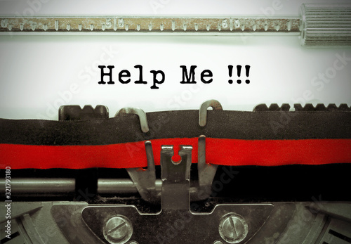 Help me by the old typewriter on white paper photo