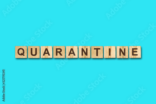 Quarantine. The inscription on wooden blocks on a blue background. Viruses. Epidemic.
