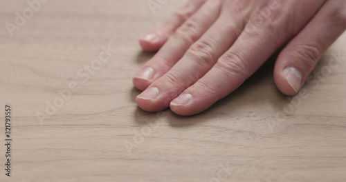 man hand touches black walnut board