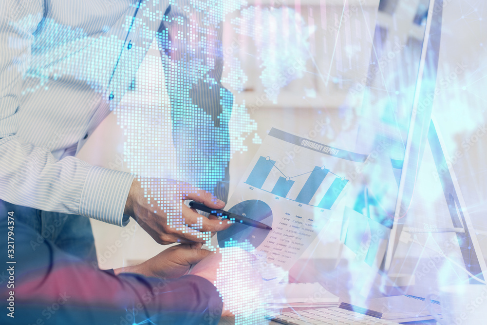 Fototapeta premium Double exposure of chart with businessman typing on computer in office on background. Concept of hard work.