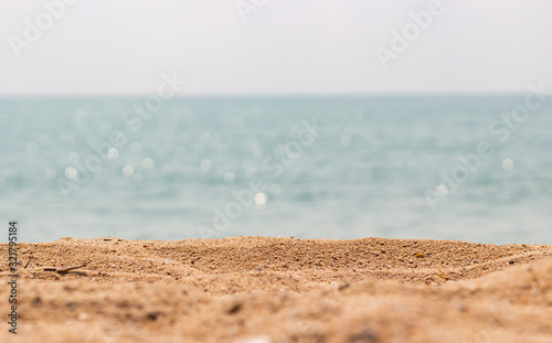 Fototapeta Naklejka Na Ścianę i Meble -  Close up surface of sand on the beach and blur foreground and blur bokeh sea background