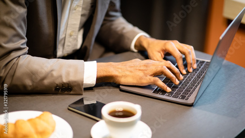 Cropped image of busy guy using computer