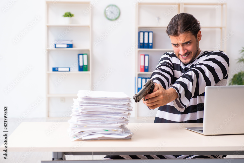 Young employee feeling like prisoner at work Young employee feeling like prisoner at work