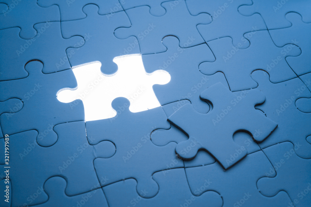 Missing piece of jigsaw puzzle with light glow, business concept for completing the final puzzle piece Missing piece of jigsaw puzzle with light glow, business concept for completing the final puzzle piece