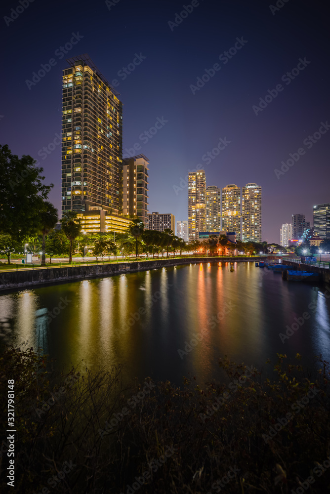Along Kallang river, Singapore - 2019 - reflection of a building standing near the river bank during blue hour