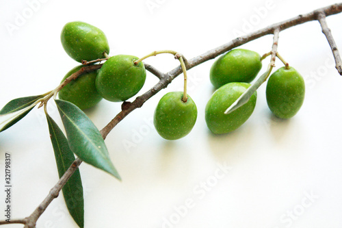 Olive branch with green olives isolated on white background.