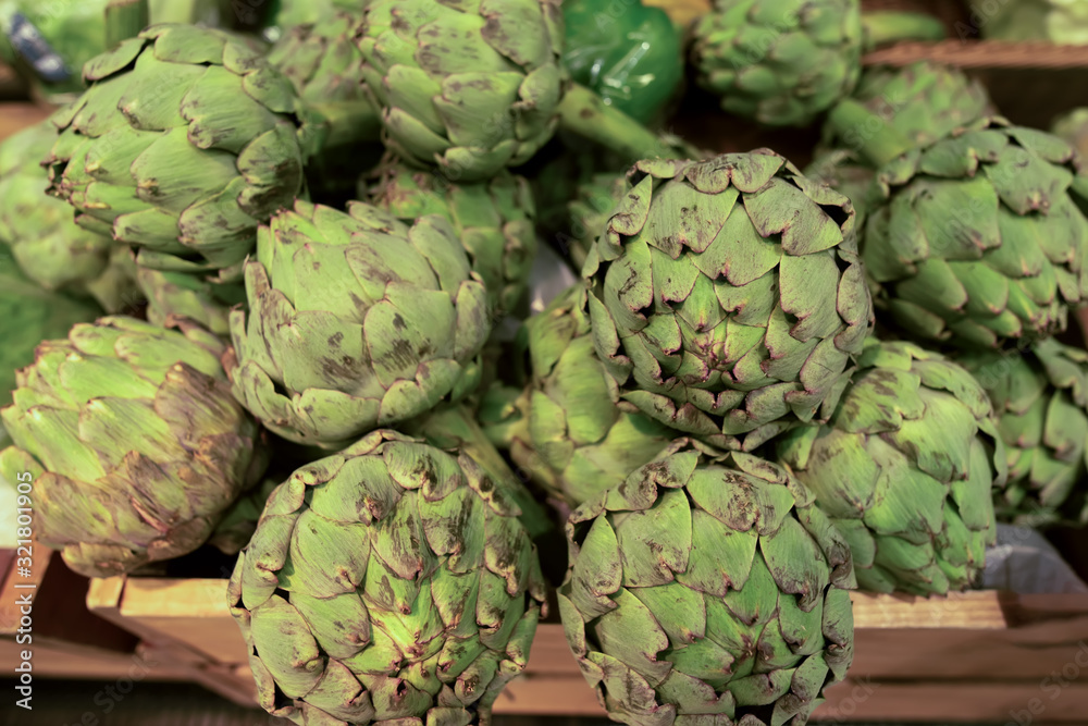 Fototapeta premium Fresh green artichoke in wooden box on the market
