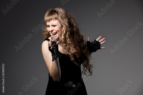 Woman in black dress and gloves singing