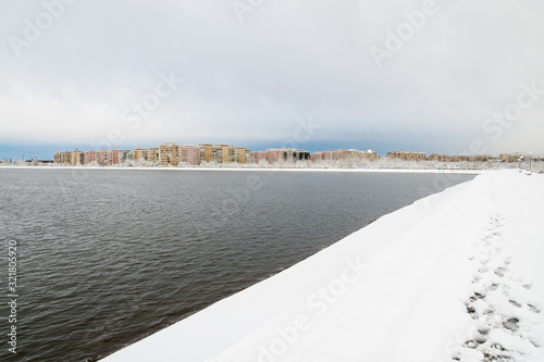 A Beautiful Urban Winter Landscape as Seen from the Lakeafter the First Snow Has Fallen 