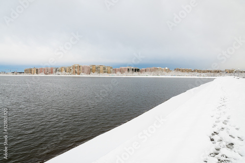 A Beautiful Urban Winter Landscape as Seen from the Lakeafter the First Snow Has Fallen  photo