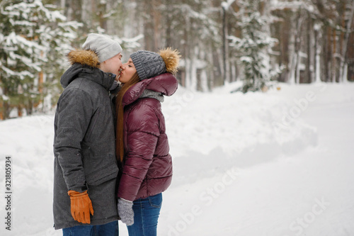 Couple kissing in winter park outside.