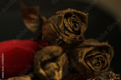 bronze tone of roses on a red velvet background