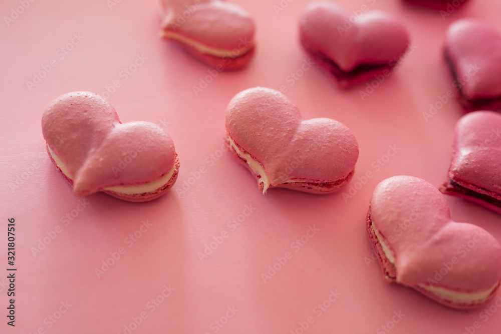 Many pink macaroons in the heart shape