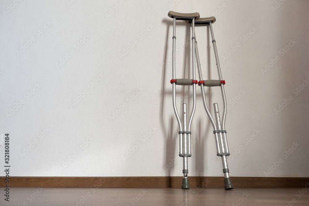 Disability. Health problems. Crutches leaning against a white wall. Rent  crutches. Difficult life of disabled people. The need to help people with  disabilities. Volunteerism. Social program. Stock Photo | Adobe Stock