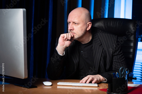 A man in a black suit in th...