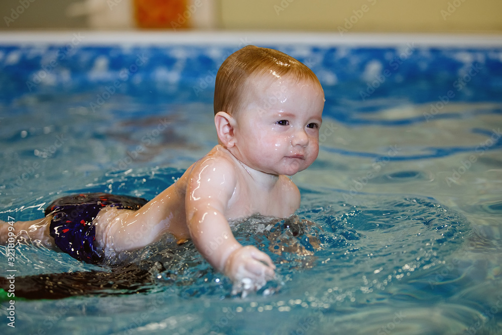 Toddler swim in water pool. Toddler swim in water pool.
