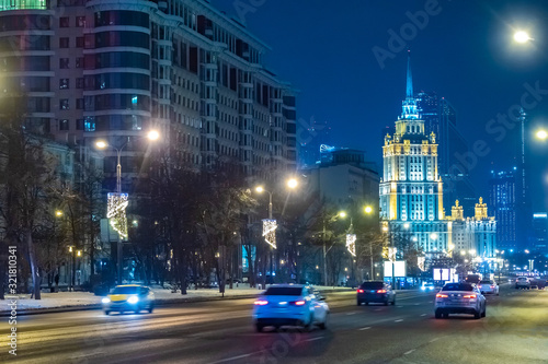 Evening Moscow. On the streets of Moscow driving cars. The capital is decorated for the New year. High-rise building with lighting. People hurry home.