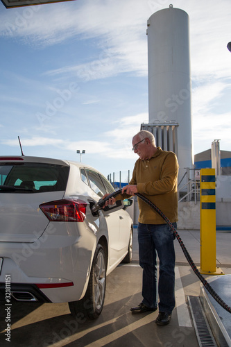 Man filling up his car.