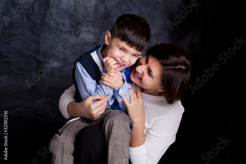 Boy and mother or happy family are playing and smiling