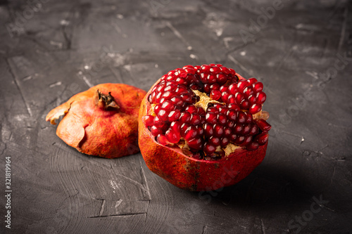 Fresh pomegranate on dark surface photo