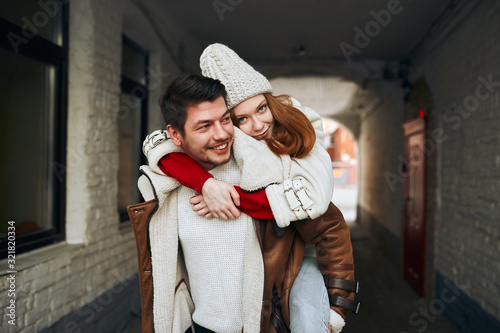 young awesome girl enjoying sitting on the back of her boyfriend, close up photo, creative unforgettbale date