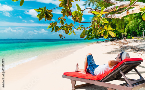 Summer lifestyle man traveler relaxing on beach chair in beautiful nature vacation exotic beach, Attraction place leisure tourist travel Phuket Trang Thailand holiday, Tourism destination scenery Asia