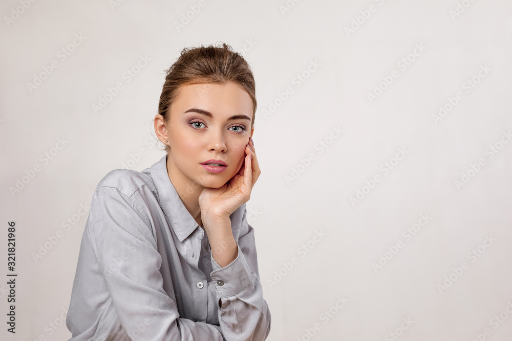 fashion portrait of beautiful tender woman in shirt on gray background. girl with perfect skin and make-up. copy space fashion portrait of beautiful tender woman in shirt on gray background. girl with perfect skin and make-up. copy space