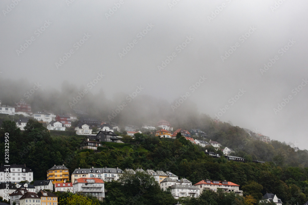 Hillside homes at Floyfjellet on a rainy and partly foggy autumn day in Bergen Norway Hillside homes at Floyfjellet on a rainy and partly foggy autumn day in Bergen Norway