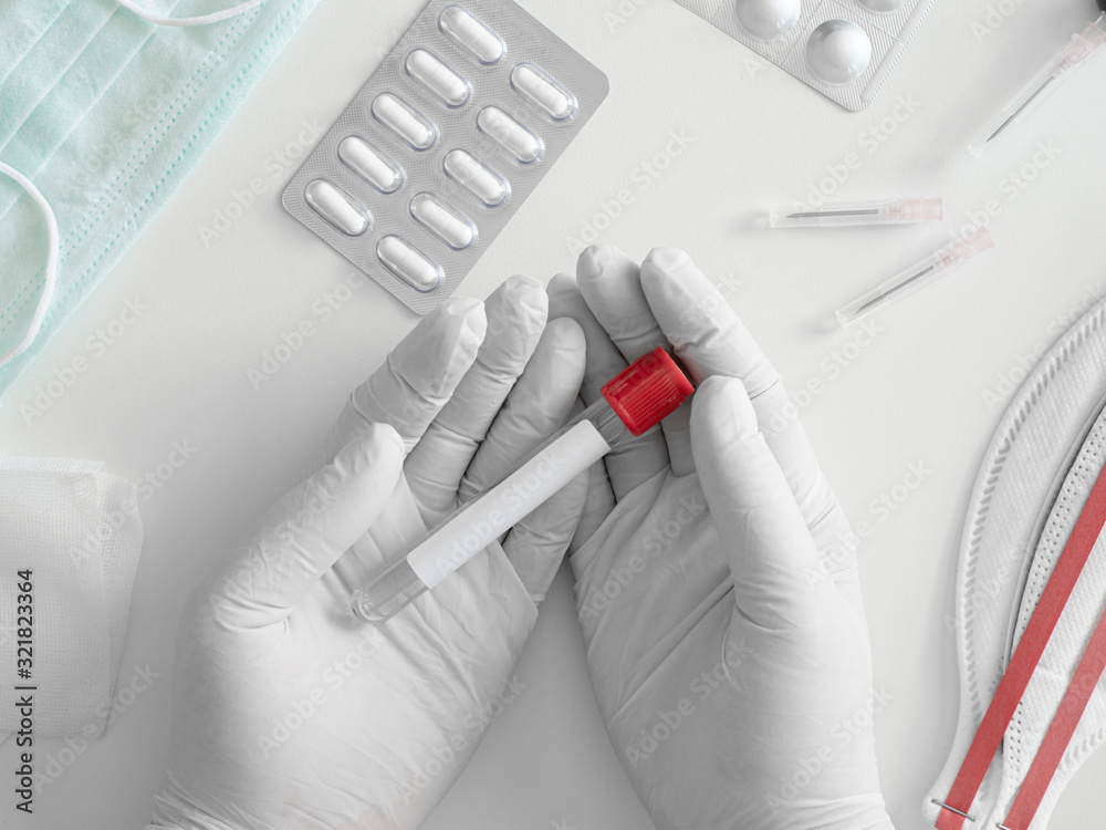 top view of Medical Concept with syringe, Medical Mask, medicine and test tube on white table background