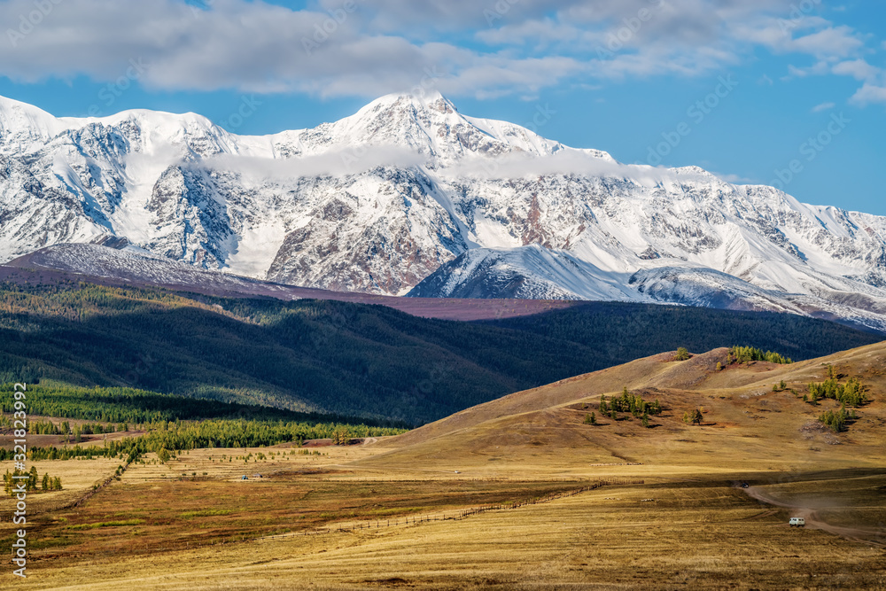 Fenced pasture in the hilly Kurai steppe, view of the North Chuysky ridge. Kosh-Agachsky District, Altai Republic, Russia