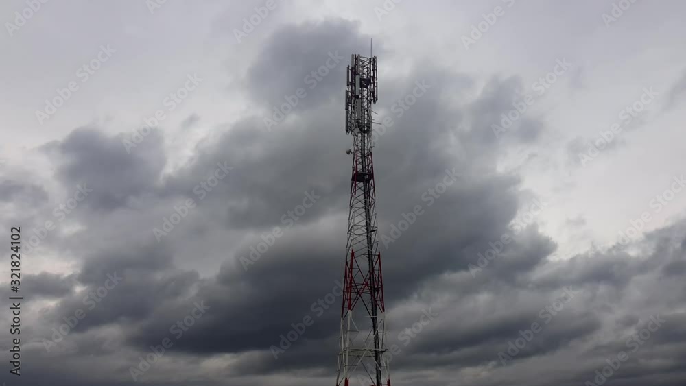 Time lapse 5G cellular Base Station Wireless Communication Antenna Transmitter. Blue sky clouds moving fast Time lapse 5G cellular Base Station Wireless Communication Antenna Transmitter. Blue sky clouds moving fast