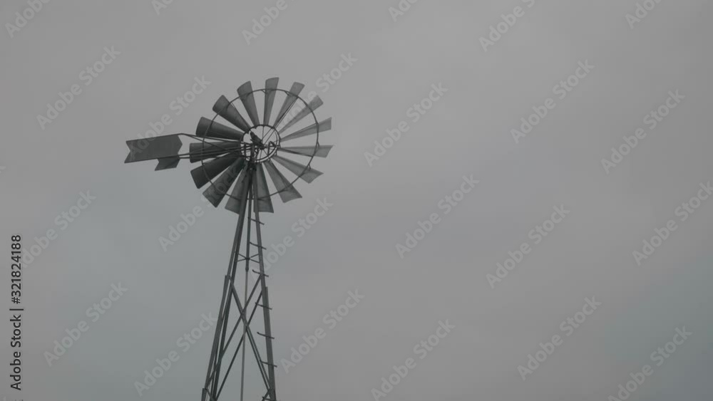 Wind Pump Blades Turning Gently In Breeze On Windmill. Locked Off Wind Pump Blades Turning Gently In Breeze On Windmill. Locked Off