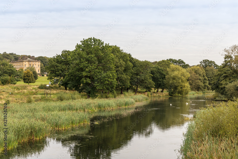 Fototapeta premium English rural landscape with River Dearne, in the Yorkshire Sculpture Park, near Wakefield in South Yorkshire.