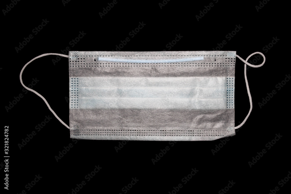 disposable medical mask close-up on a black background disposable medical mask close-up on a black background
