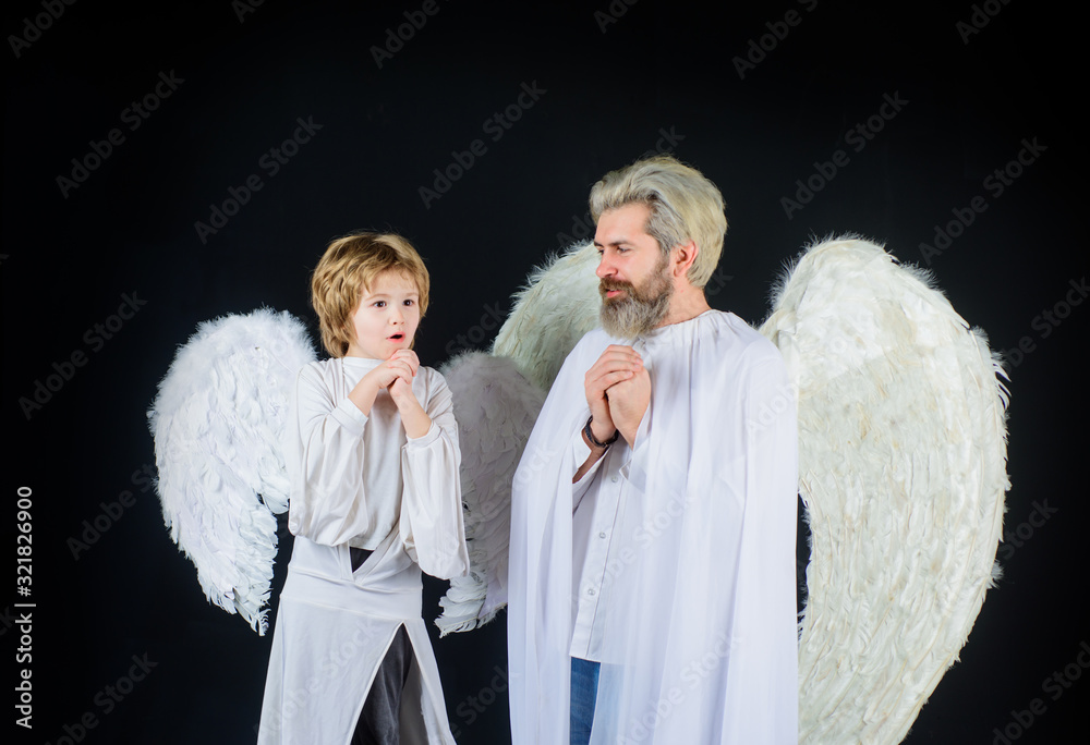 Obraz premium Happy father in angel costume with little son angel. Christmas angels. Cute angel. Gorgeous kid. Valentines day. Father and son Angels. Father's day. Little cupid boy and father in white clothes.
