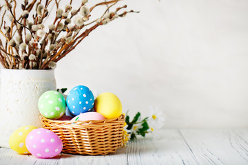 Happy Easter. Congratulatory easter background. Easter eggs and flowers. Background with copy space. Selective focus.