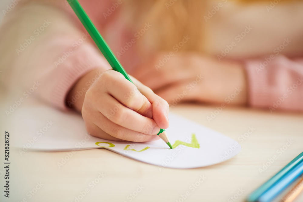 Close up of unrecognizable little girl making handmade card for Mothers day, copy space Close up of unrecognizable little girl making handmade card for Mothers day, copy space