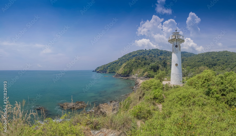 view of lighthouse on top hill with blue-green sea, mountain and blue sky background, Laem Tanod (Tanod Cape), Mu Ko Lanta National Park, Lanta island, Krabi, southern of Thailand.