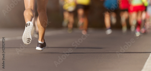 Marathon running in the light of evening, detail on legs 