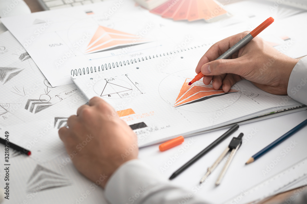 Graphic designer drawing sketches logo design. Graphic designer drawing sketches logo design.