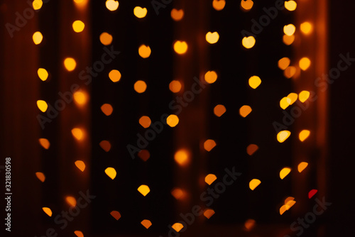 Abstract blur defocused background black  red and yellow lights highlights  bokeh hearts  soft focus