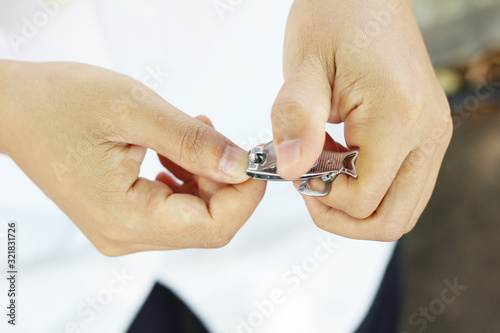 Woman cutting nails using nail clipper
