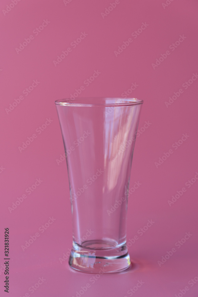 Empty luxury tall glass on pastel pink background. Empty luxury tall glass on pastel pink background.