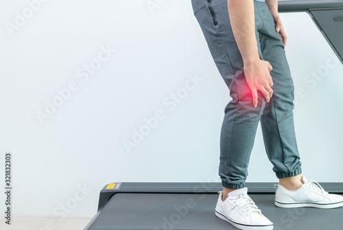 Close up young man suffer knee pain during run