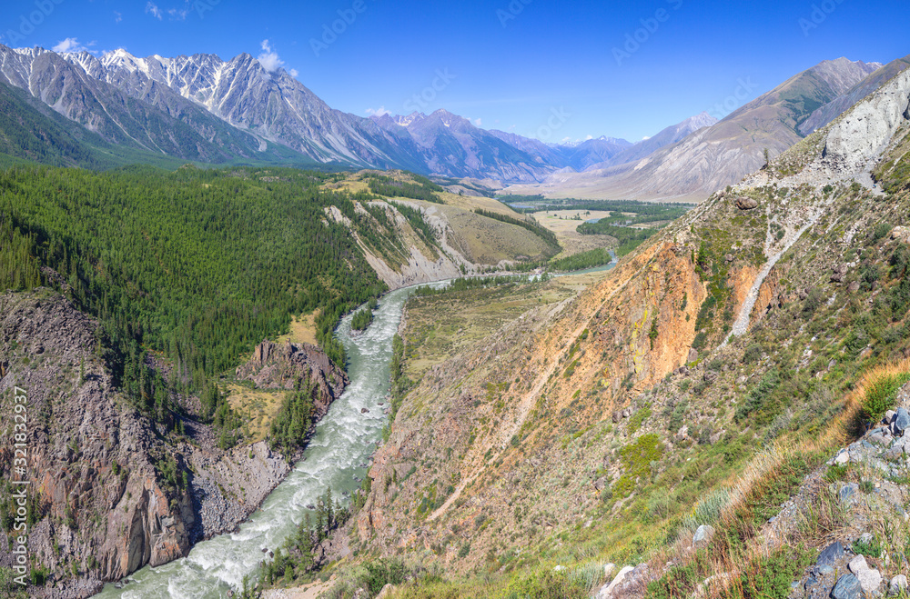 Obraz premium Above the mountain valley, the river flows among the mountains, Altai. Travel and vacation in the mountains.