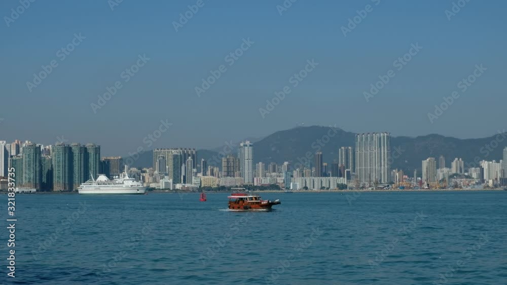 ships and ferry boat near coast of Hong Kong with city skyline background ships and ferry boat near coast of Hong Kong with city skyline background